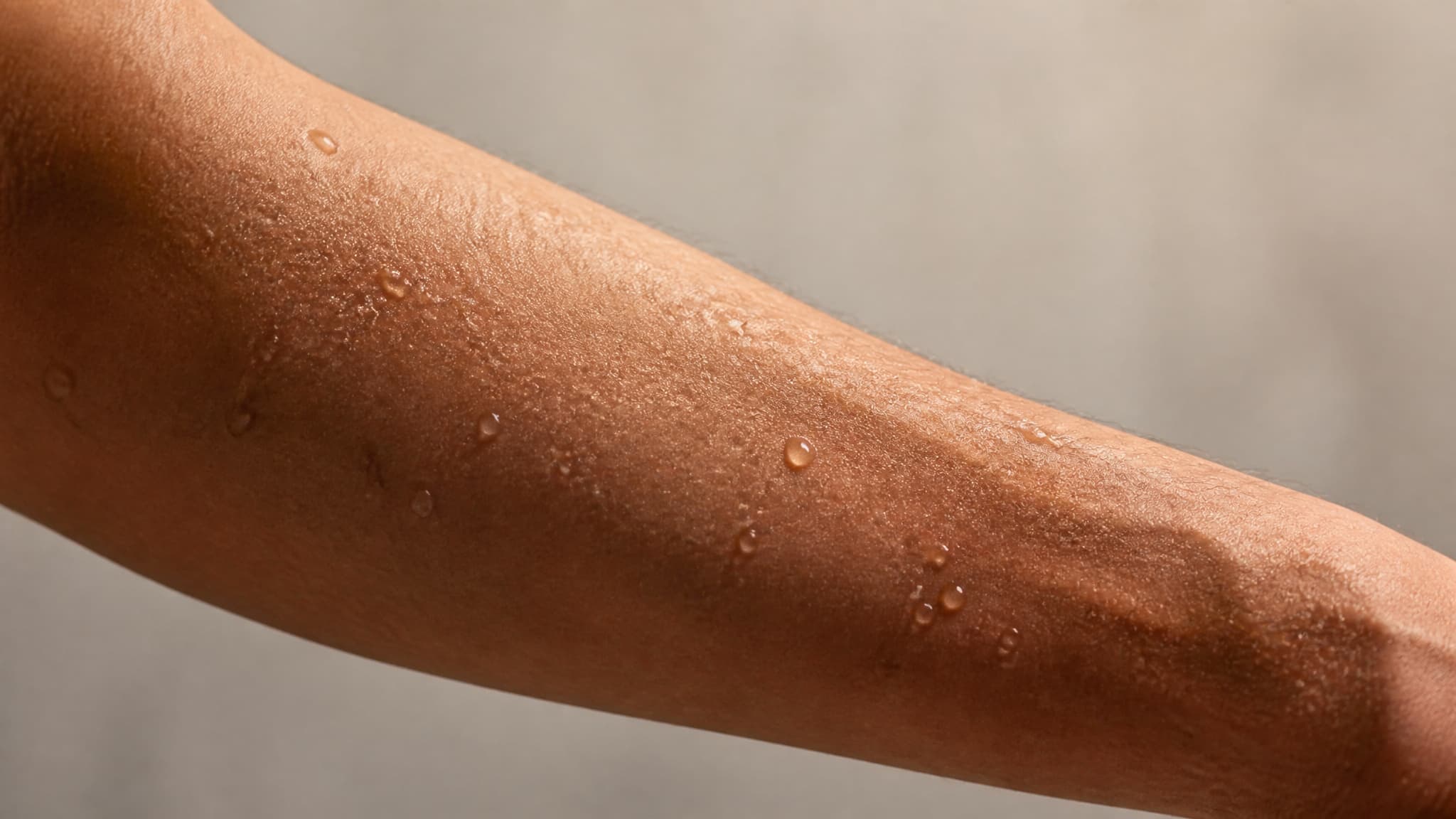 Close-up of sweating skin during an infrared sauna session illustrating cardiovascular and cellular stress response.